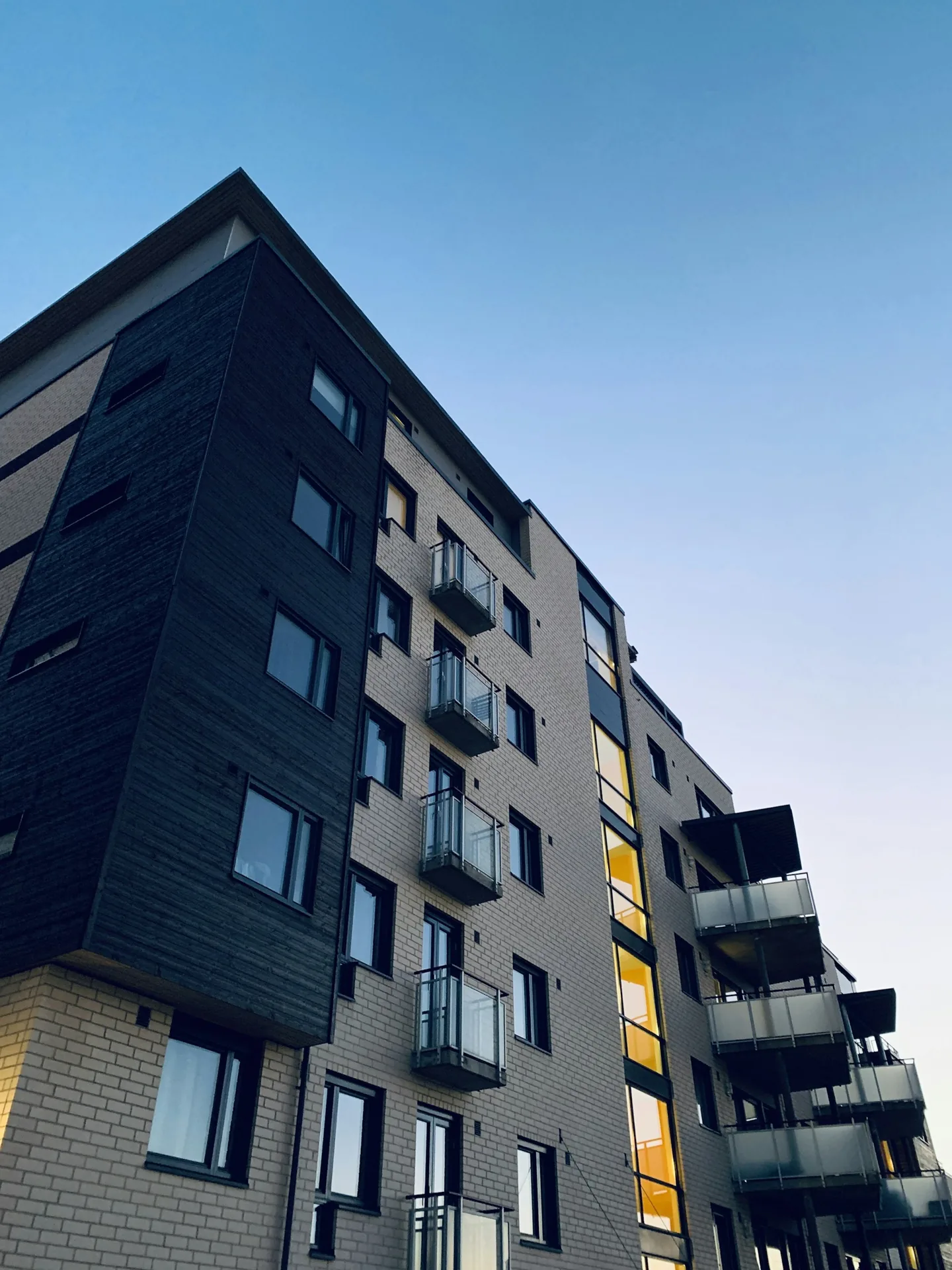 Apartment building facade with balconies against the sky