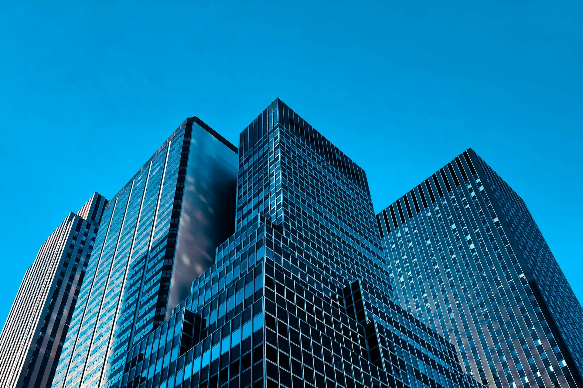 Glass towers against a blue sky